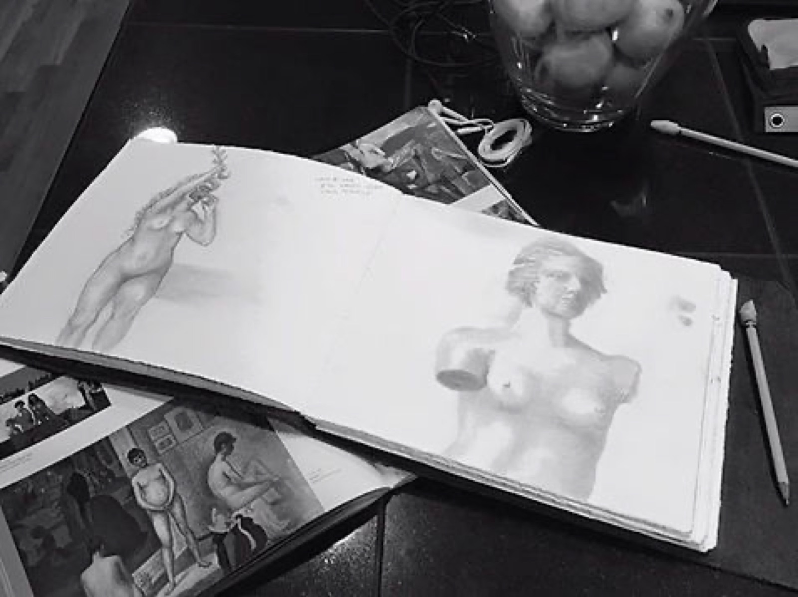 Open sketchbook with figure studies